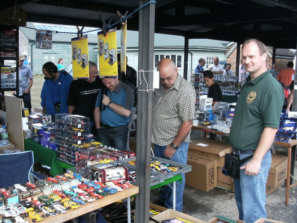 One of the swapmeet stands with tables covered in slot cars