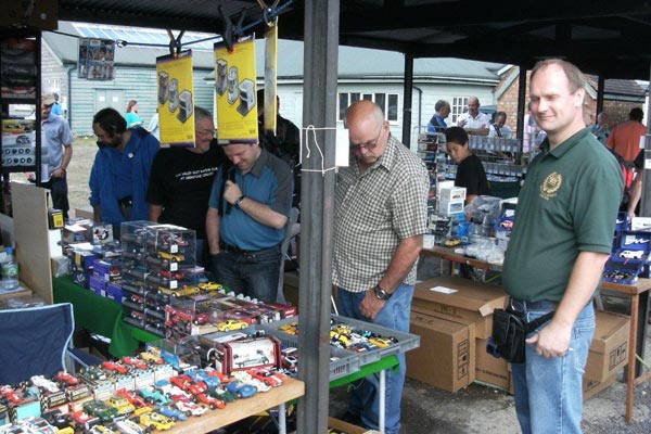 One of the swapmeet stands with tables covered in slot cars