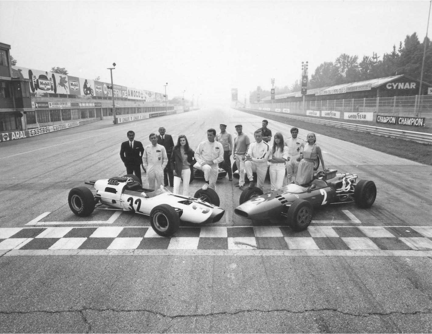 The cast of Grand Prix on the main straight at Monza