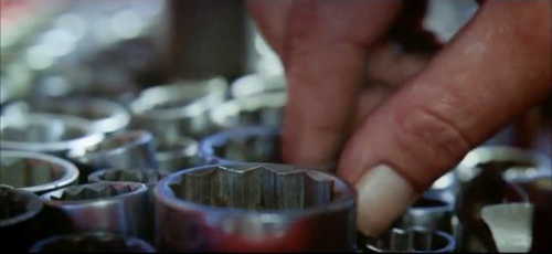 Opening credits, close up of a hand reaching into a toolbox