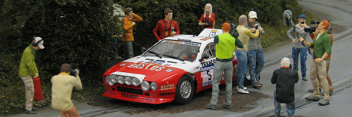 Model figures around a Lancia slot car